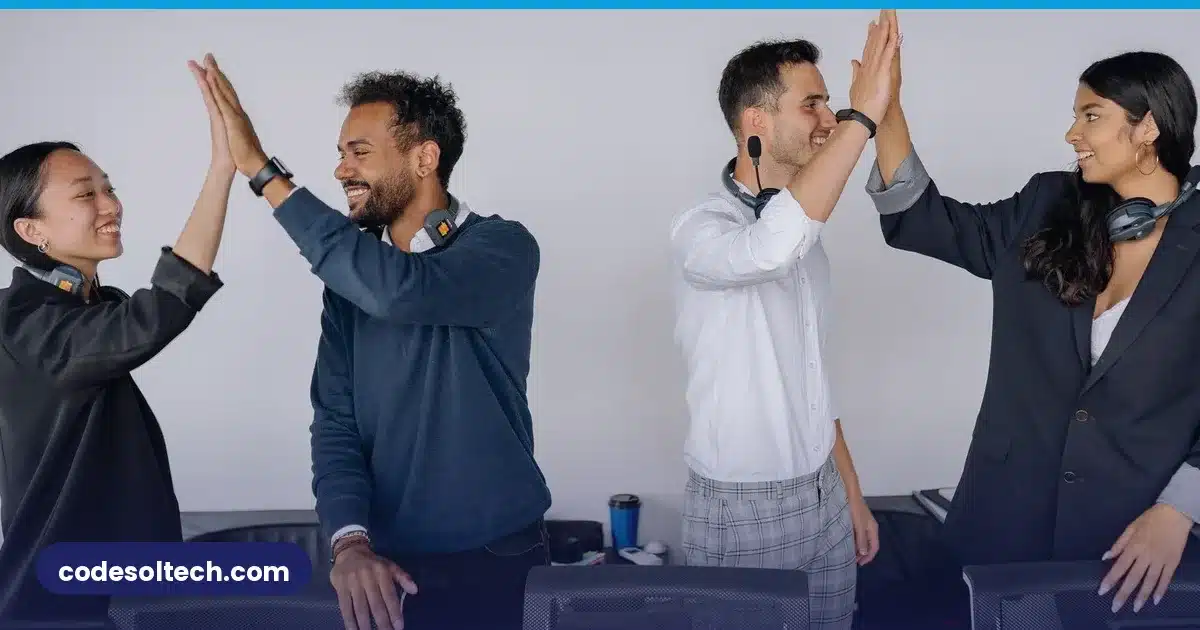 Startup team celebrating success with high fives